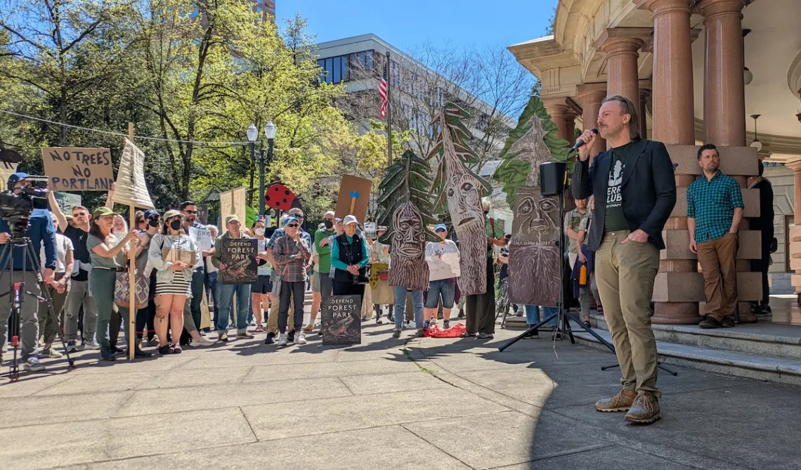 A photo of a large rally crowd outside Portland City Hall in the sunshine