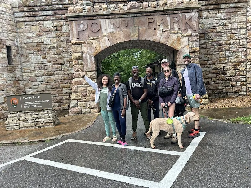 a group of seven people and a dog pose for a picture
