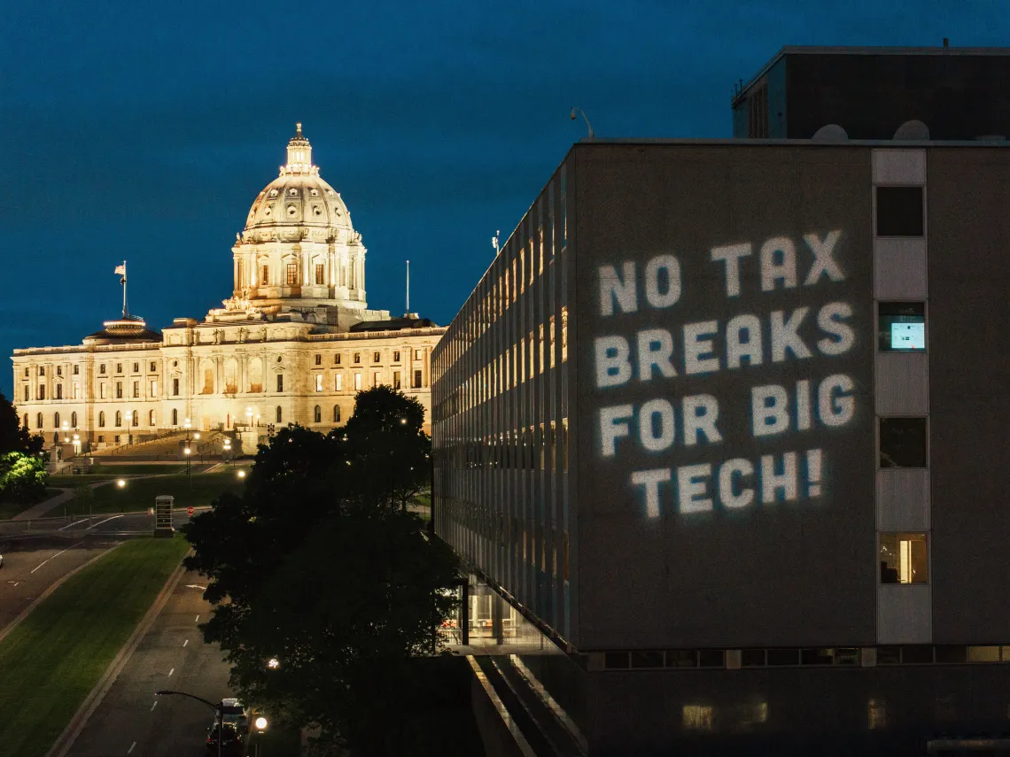 We shined a literal light on the building where the negotiations on data center tax breaks for some of the richest people on earth were taking place. Photo credit: Devon Young Cupery