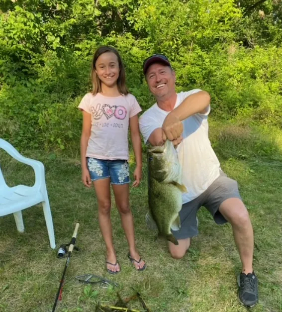 Photo of father and daughter who caught a bass in Walnut Trail Pond!