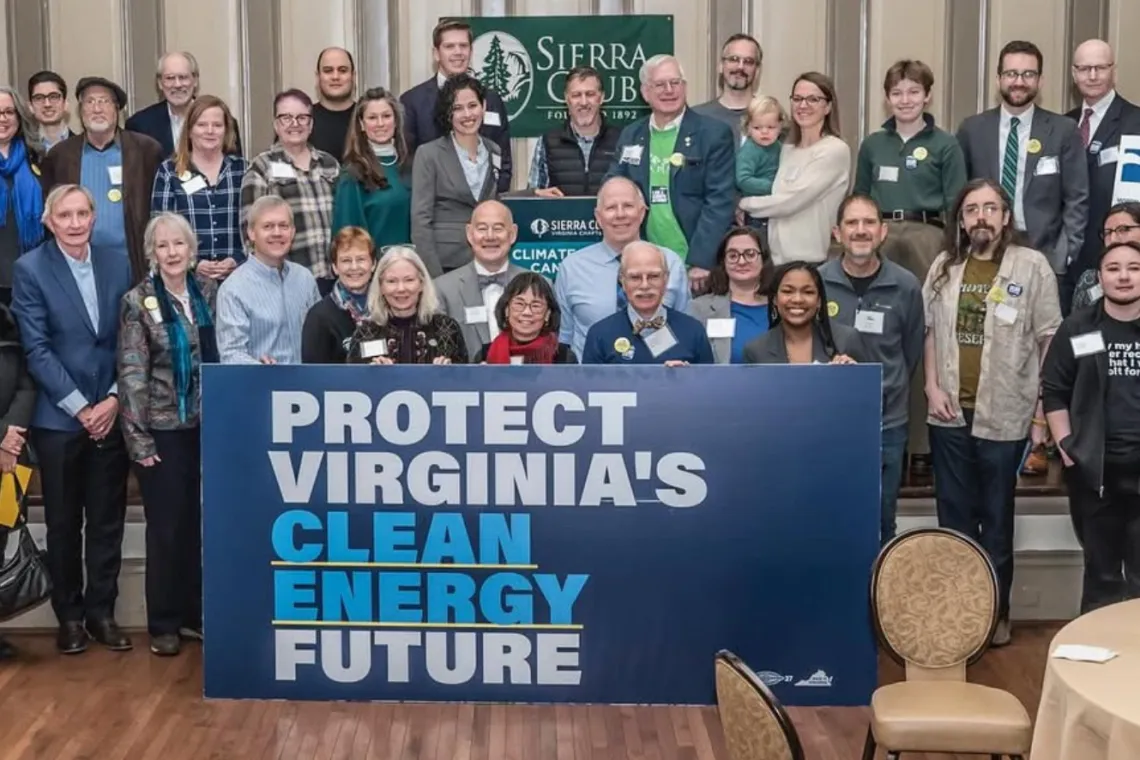 Grassroots leaders posing with a clean energy sign