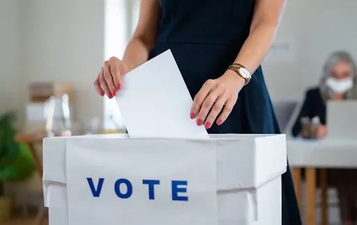 A person turning in their ballot