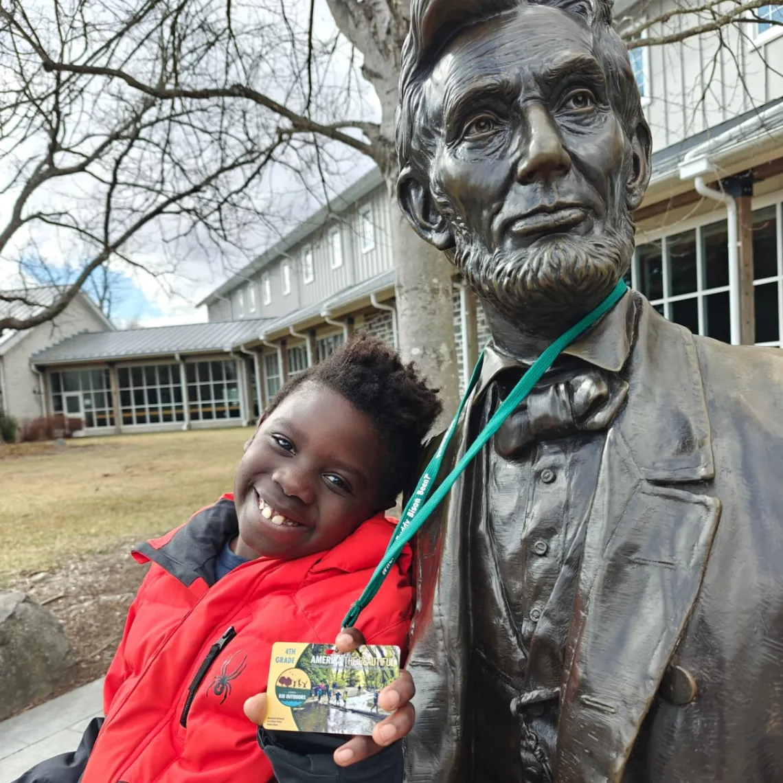 Dylan shares his Every Kid Outdoors pass with a statue of President Abraham Lincoln at Gettysburg National Military Park in Pennsylvania.
