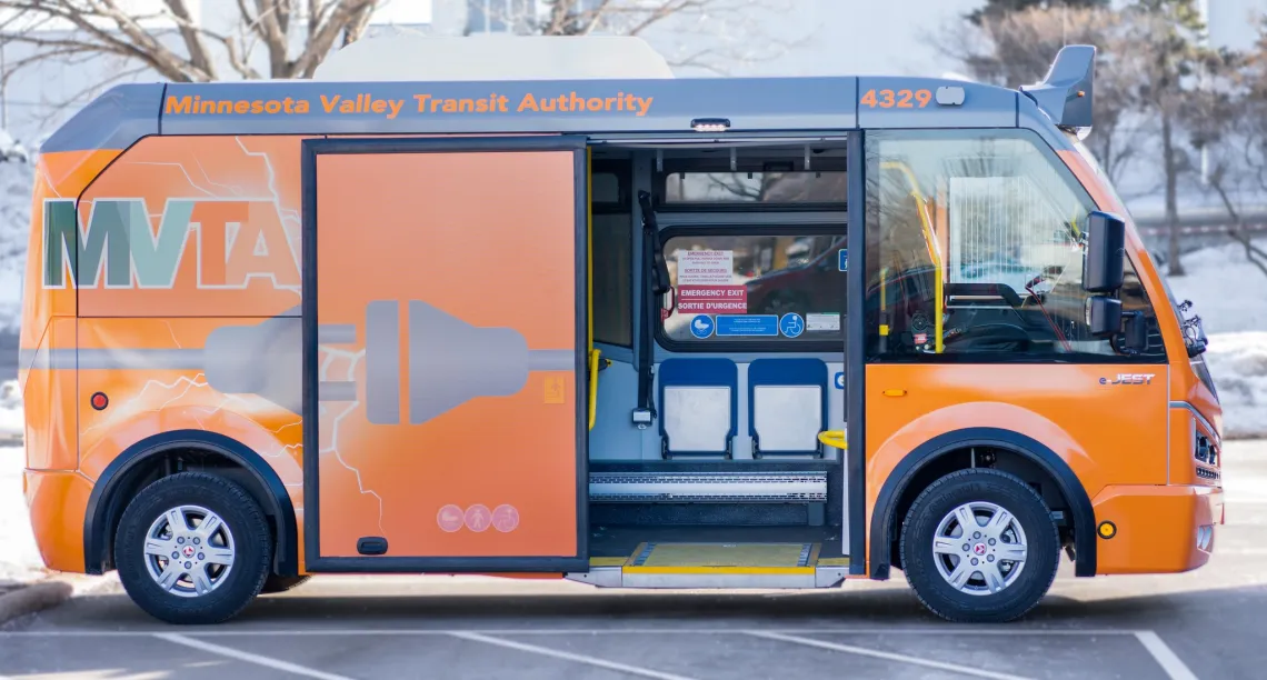 MVTA's orange electric mini-bus with the door open parked in a parking lot