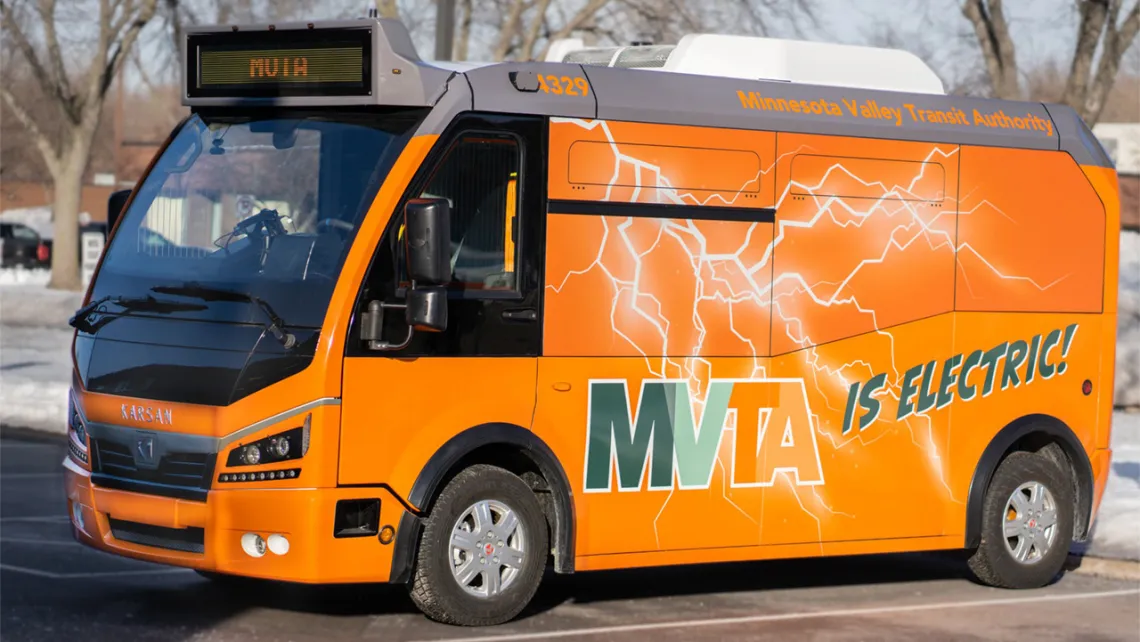 MVTA's orange electric mini-bus parked in a parking lot