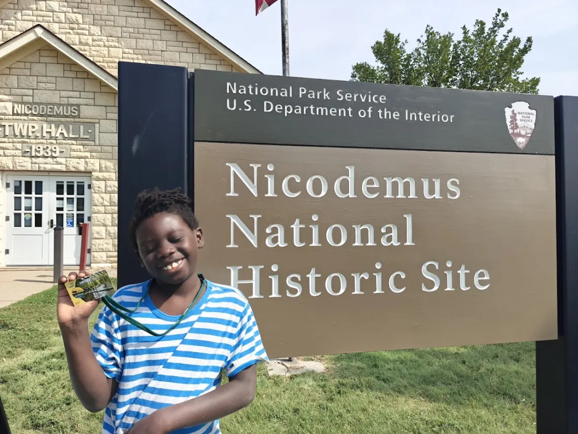 Dylan outside the Nicodemus town hall, now a visitor center at Nicodemus National Historic Site in Kansas.