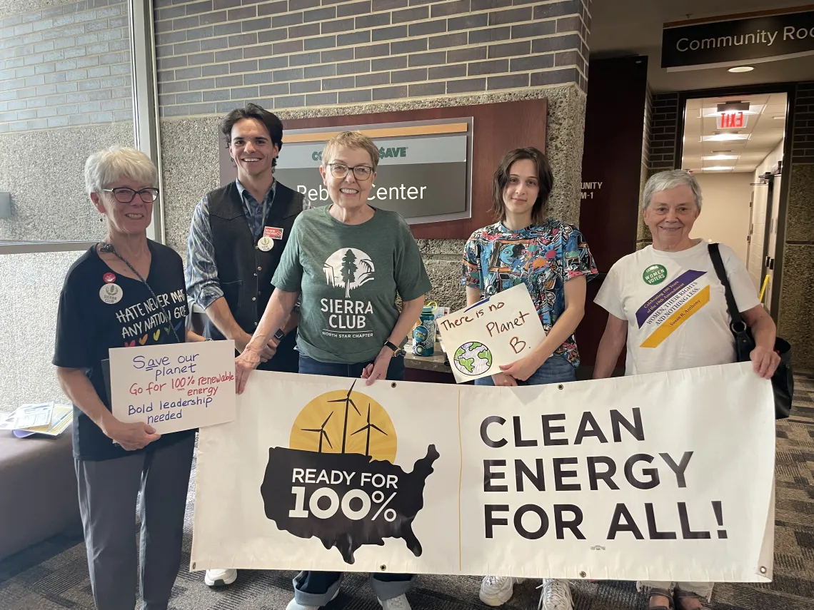 Sierra Club members hold a 100% Clean Energy for All banner