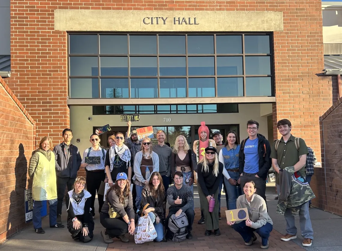 A group of people posing for a photo outside Bend City Hall