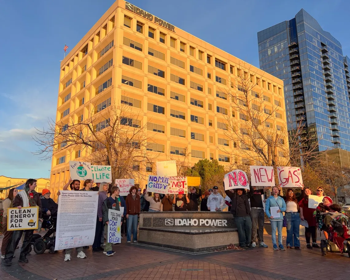 Picture of young people holding signs that say No New Gas in front of Idaho Power's headquarters building