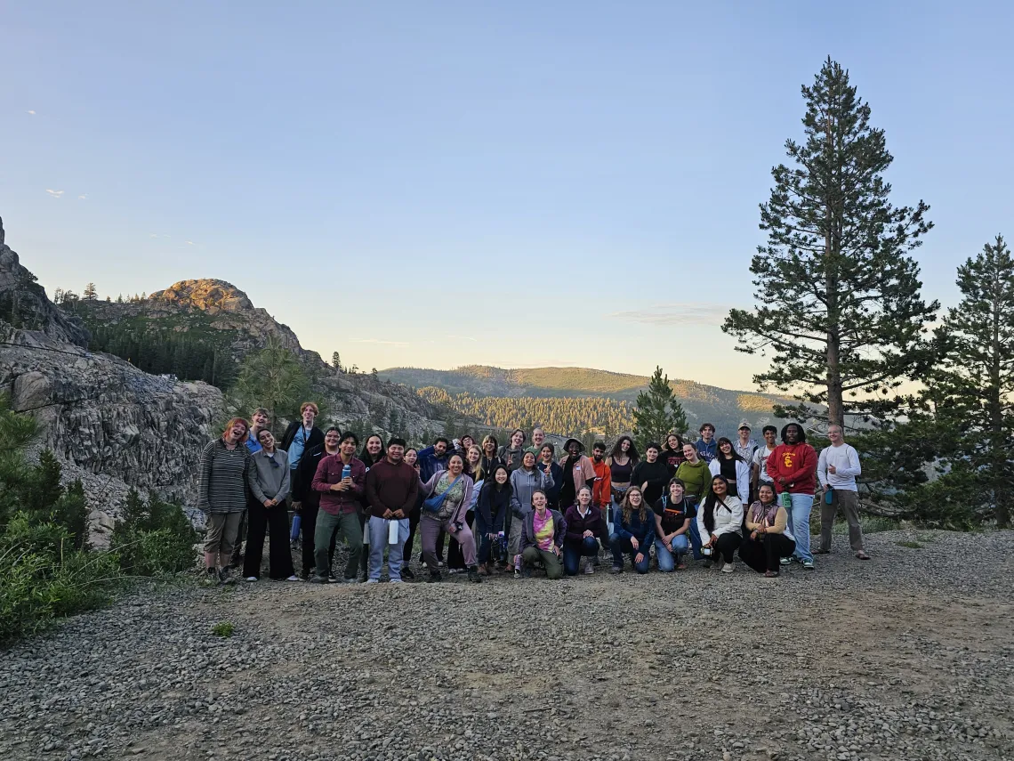 A picture of a large group of young adults in a group in the outdoors