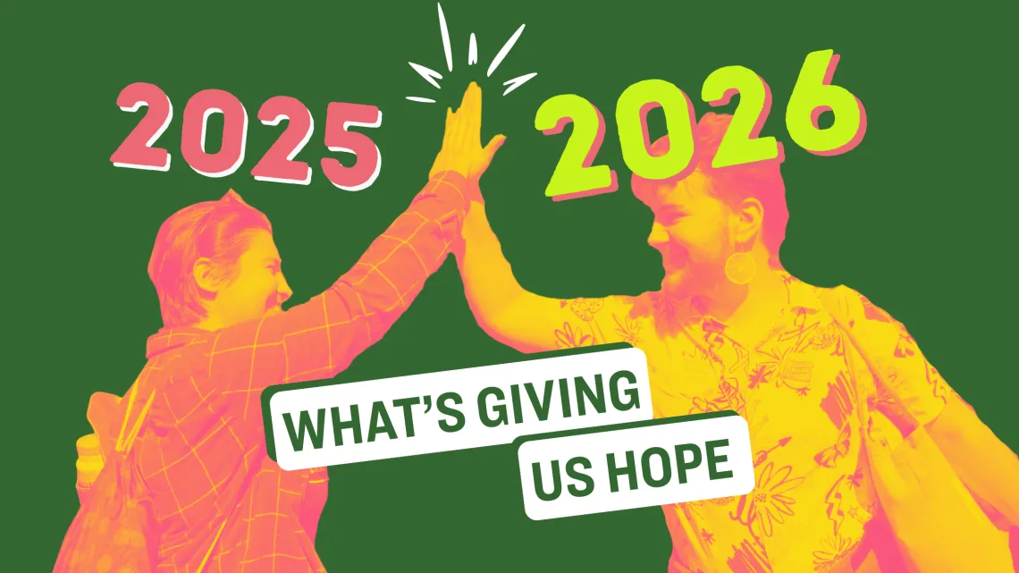 A photo of two young people high-fiving