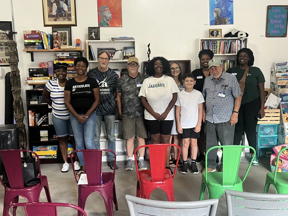Group photo of supporters and activists in Jacksonville standing up gathering in a meeting room.