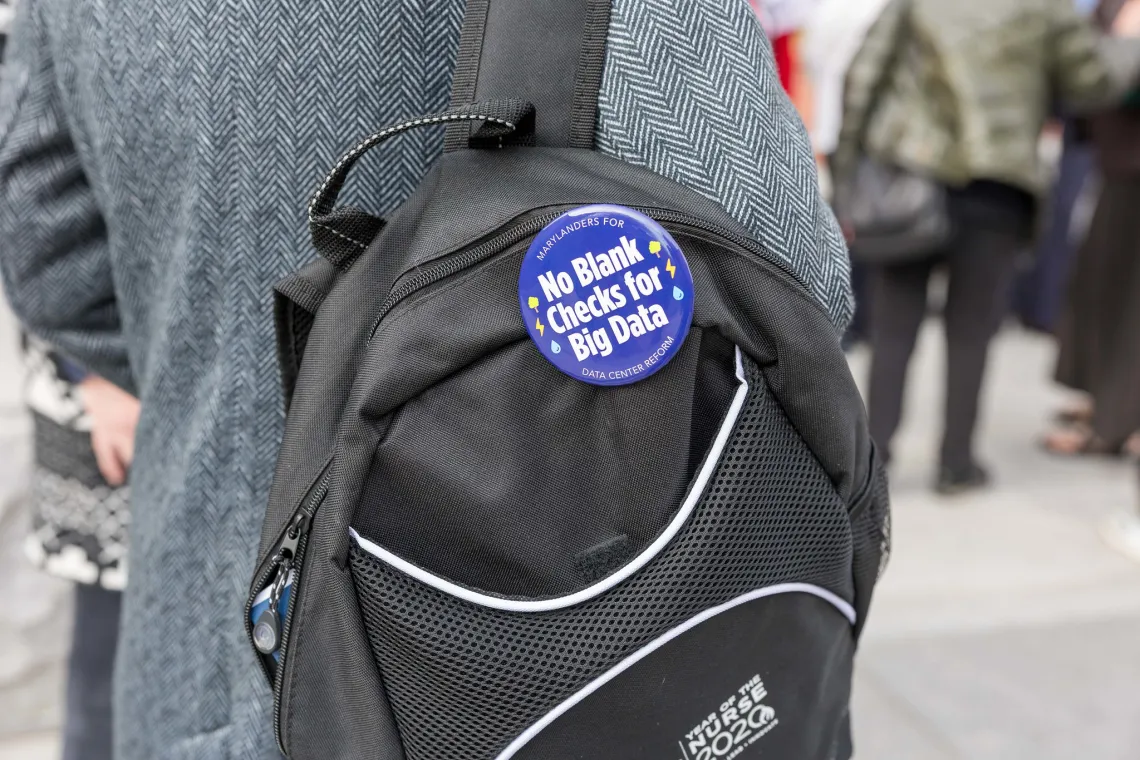 Button on backpack, No blank check for big tech