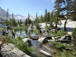 Hikers Crossing Stream