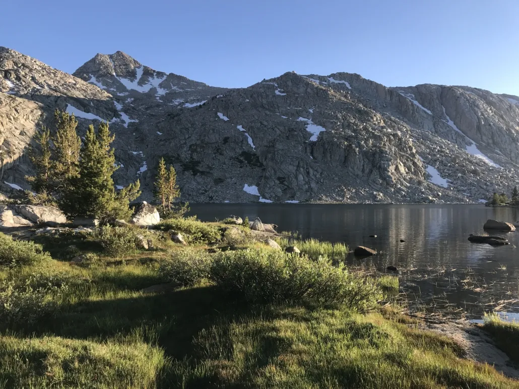 Grass and Lake in front of rugged mountains