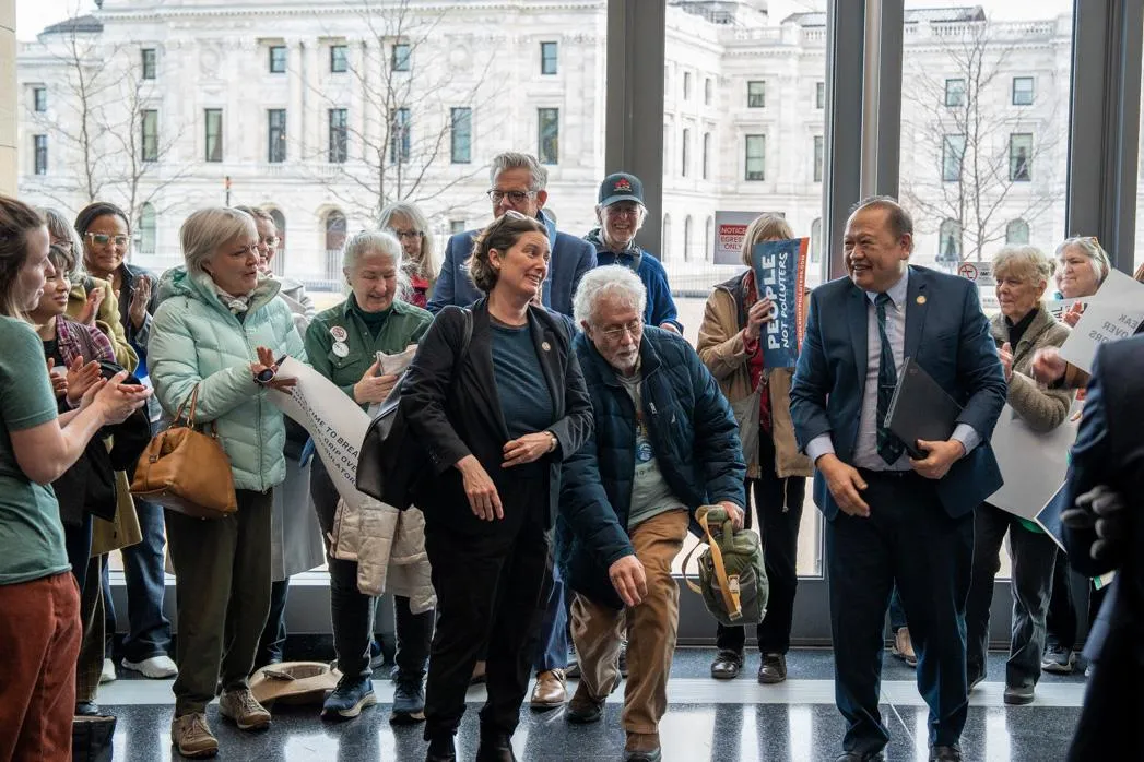 Attendees applaud Senators Jen McEwen and Foung Hawj for their leadership. Photo by Devon Young Cupery