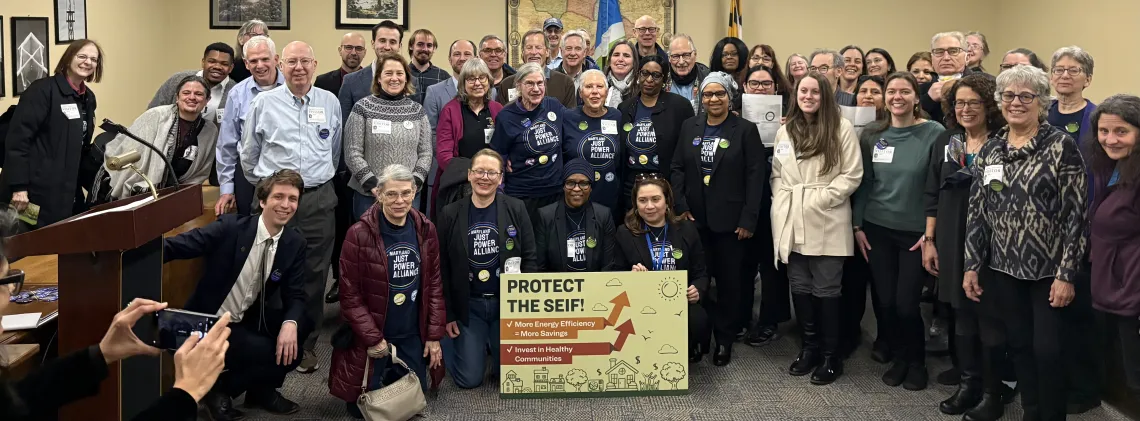 people posing for a photo holding a sign that says "Protect the SEIF"