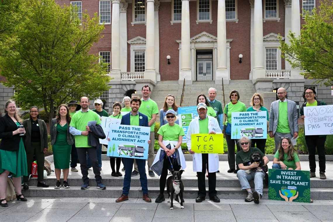 people in front of the Maryland state house at a rally posing for a photo 