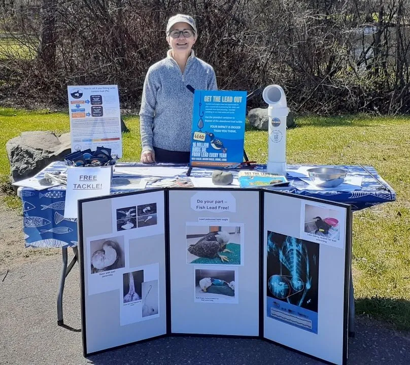 Dana tabling at the Fishing Opener with nonlead samples and information