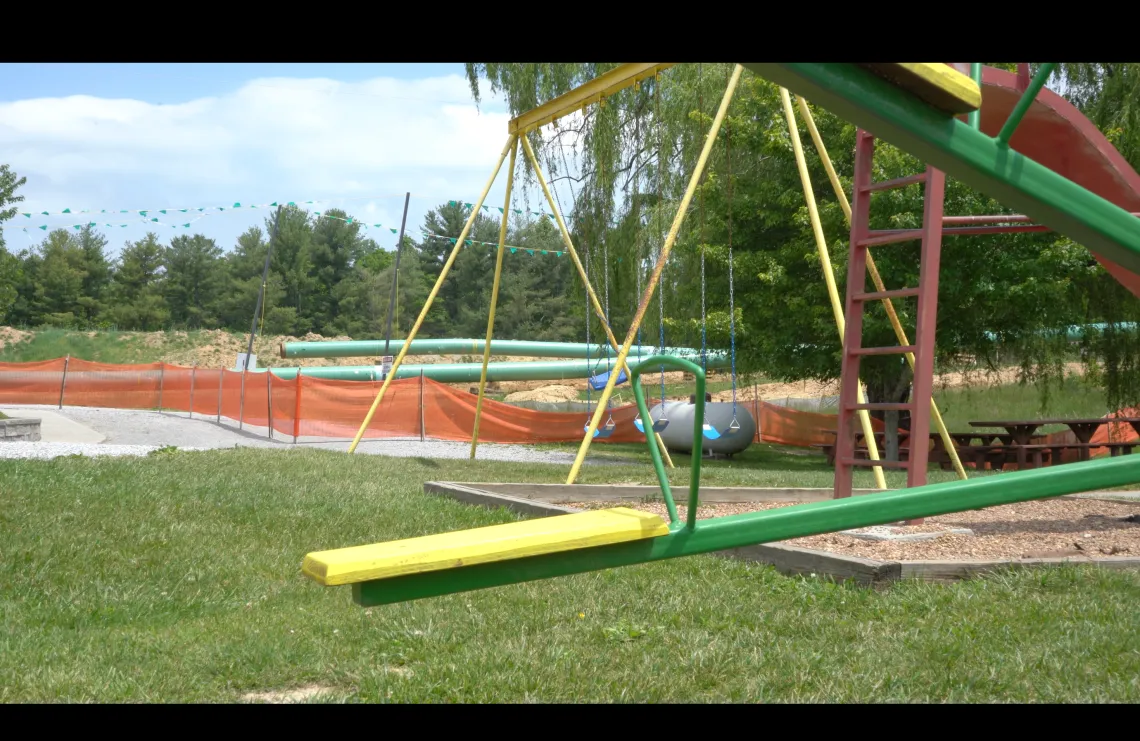 A playground in front of pipeline construction.
