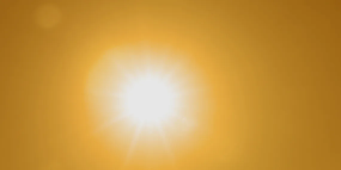 A blurry photo looking directly into the sun in the sky