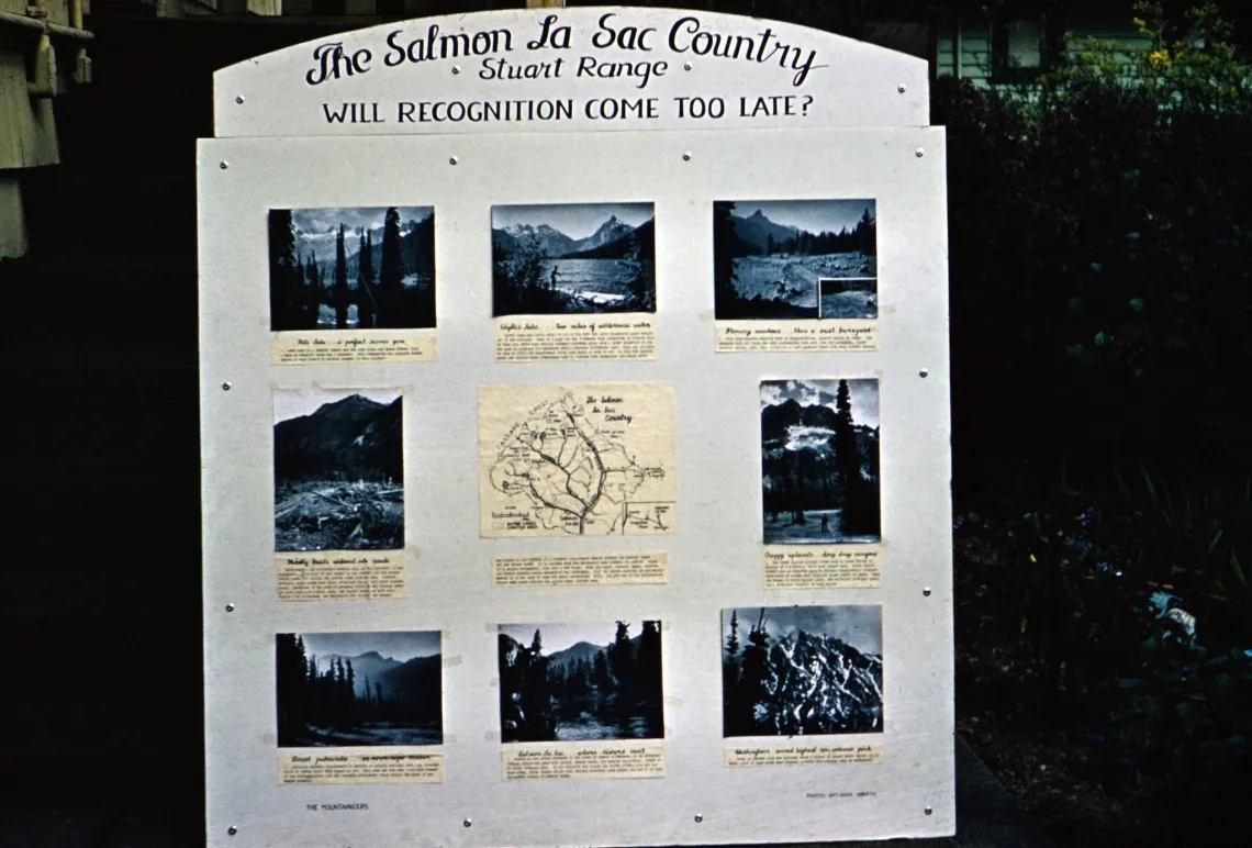 A sign from 1959 with several black and white photos of various alpine landscapes that says "the Salmon La Sac Country, Stuart Range, will protection come too late?"