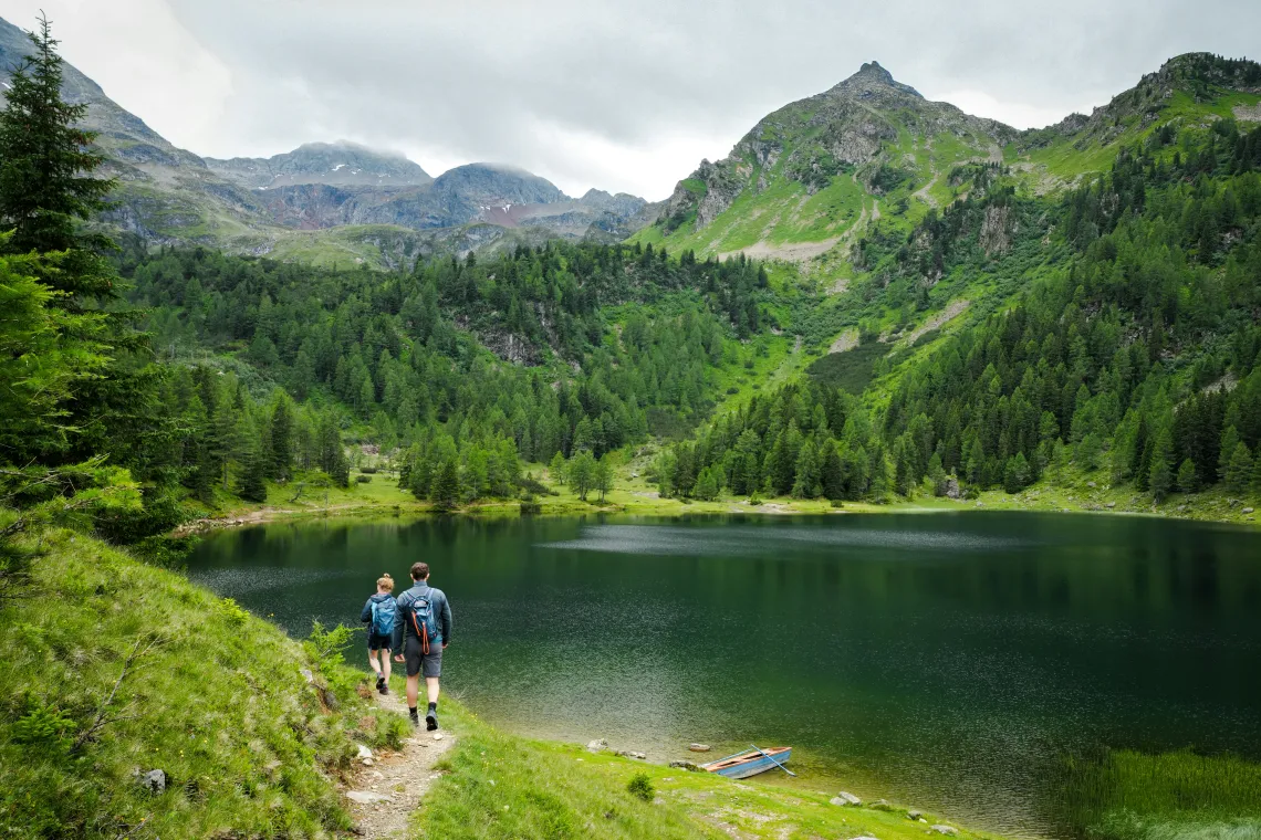 Hikers hiking around a lake