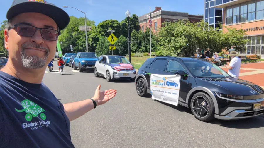 EV Lineup: Stan Jaracz showing off the lineup of the 5 EVs participating in the parade. From right to left:  Hyundai Ioniq 5, BMW, Rivian, Smart Car (hard to see), and Kia EV9.  Picture taken by Stan Jaracz.