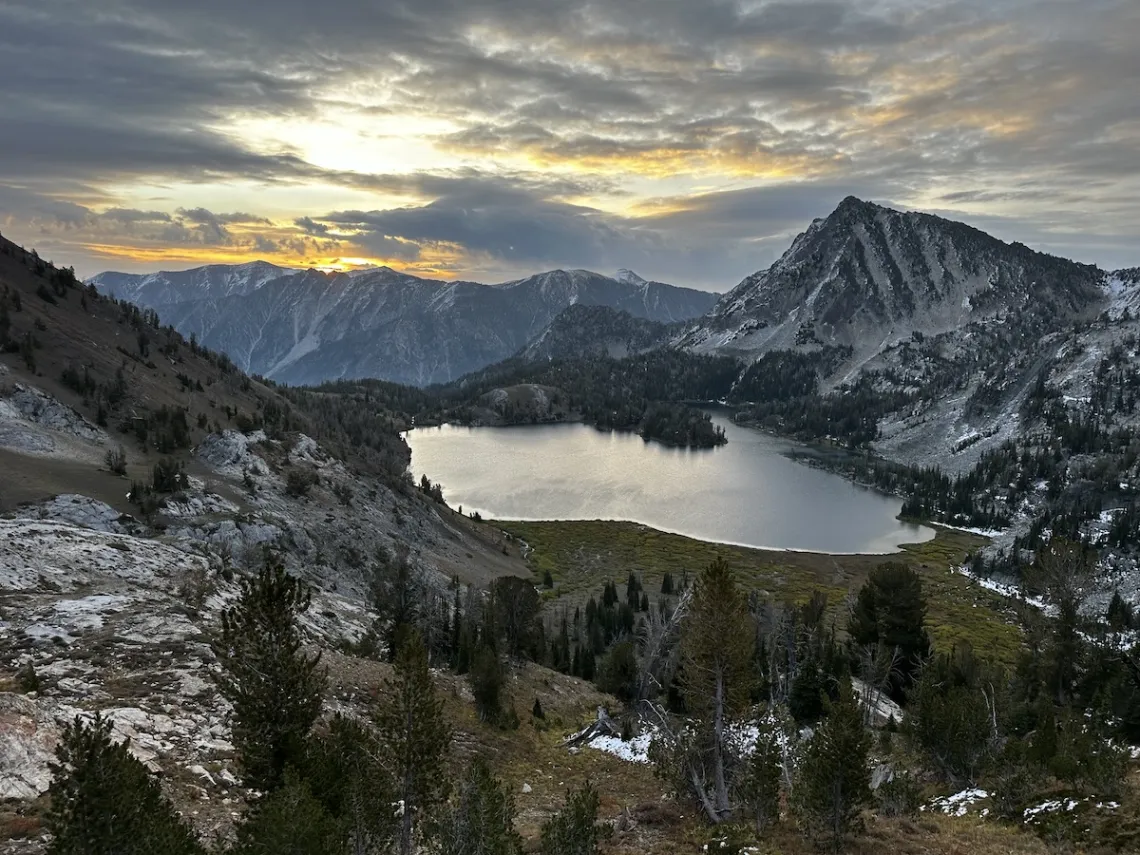 A photo of an alpine lake at sunset