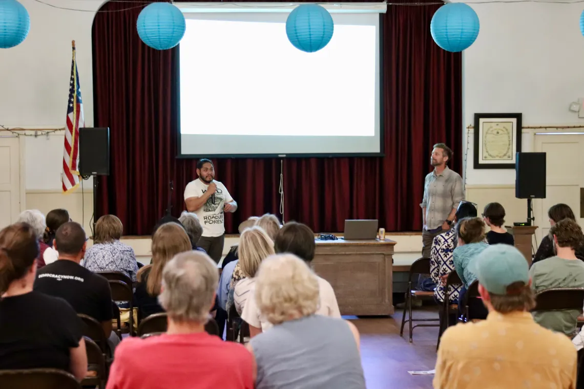 two speakers in front of an audience at the Roadless Rule town hall in San Luis Obispo