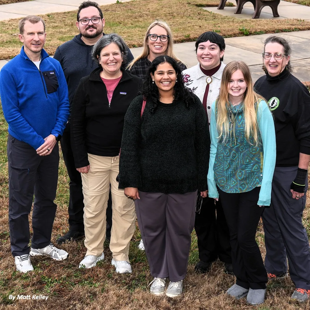 The NC Chapter staff pose for a group photo on a grassy lawn