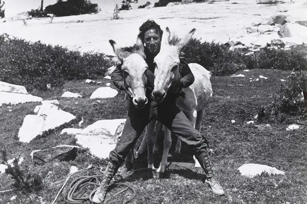 A man holding the necks of two burrows