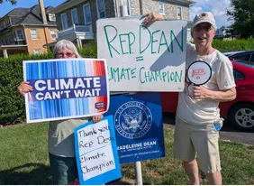 Volunteers holding signs