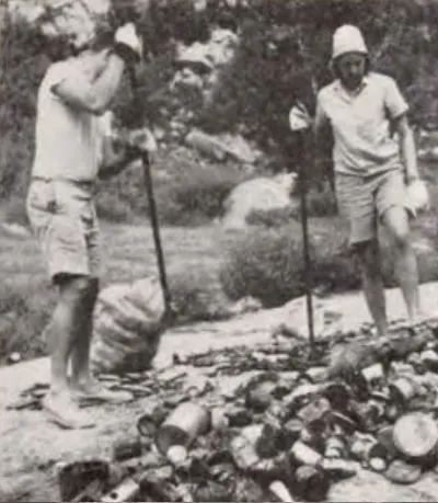 Two people cleaning up refuse