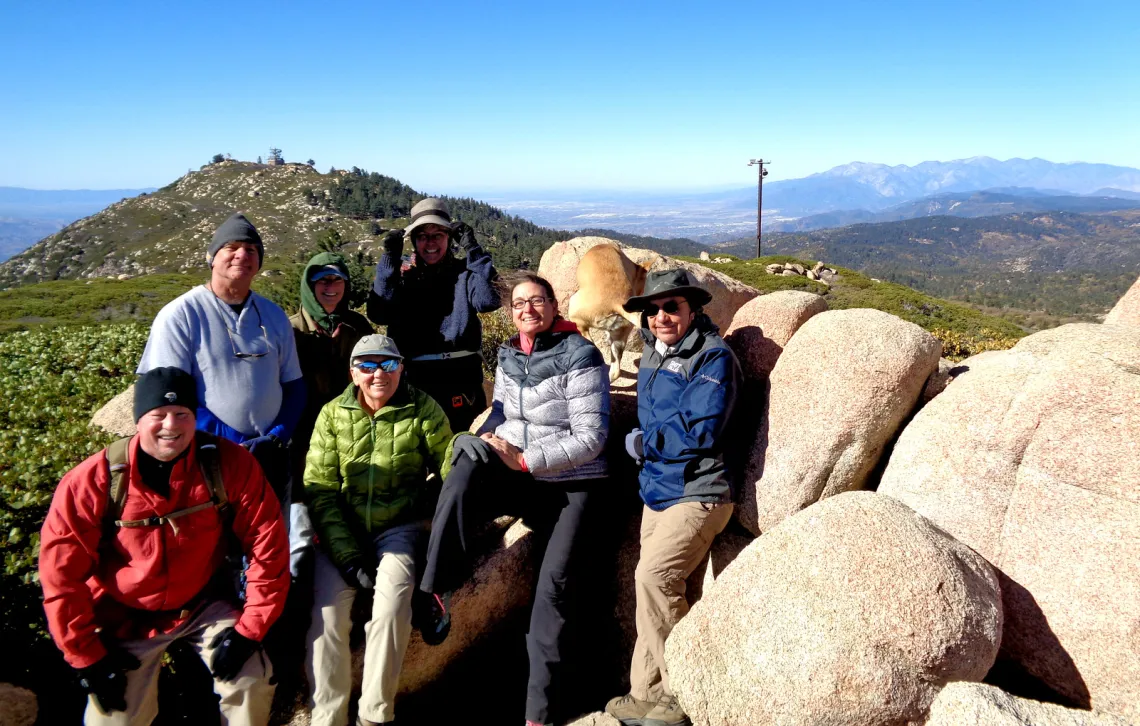 Members of the mountain group posing for a photo on boulders near Slide Peak, looking towards Keller Peak. Roadless Area in the San Bernardino National Forest. photo by Karla Kellems