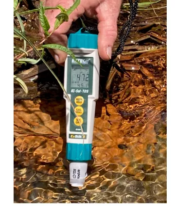 The low temperature measured here (the small number, 45.1 degrees F) as compared to the water temperature of the nearby stream (72 degrees F) demonstrates that this is groundwater upwelling to the land surface. Photo Credit: Waadookawaad Amikwag