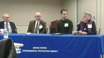 3 men and 1 woman seated at table with blue EPA tablecloth