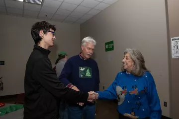 Congresswoman Dina Titus shaking hands at holiday party