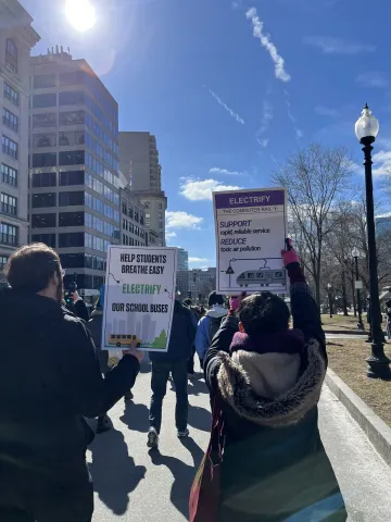 People holding signs at the Transit Equity Day rally