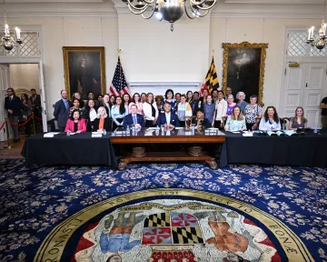 Group of people at Maryland State House for bill signing. 
