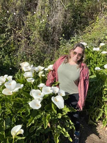 Erika stands amongst lilies