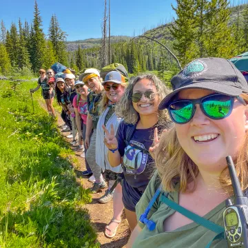 kirsten and a group our outings participants posing for a photo while hiking