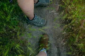 feet with hiking shoes in grass