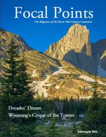 Magazine cover features a mountain landscape. Snow remains in the low spots of the foreground. A towering, sheer rock rises in the background