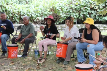 Participants form a drum circle