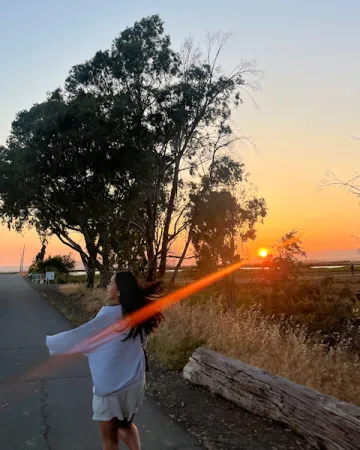 Woman in wetlands at sunset