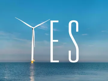 Offshore winfd turbine helping spell out the word "YES" in the ocean. 