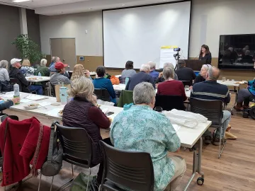 Chapter Chair Mila Vujovich-LaBarre introduces the speaker at a General Meeting