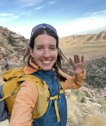 Portrait of Lia Brewster smiling on a hike