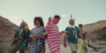 Picture of five men dressed up in funny costumes having fun outdoors
